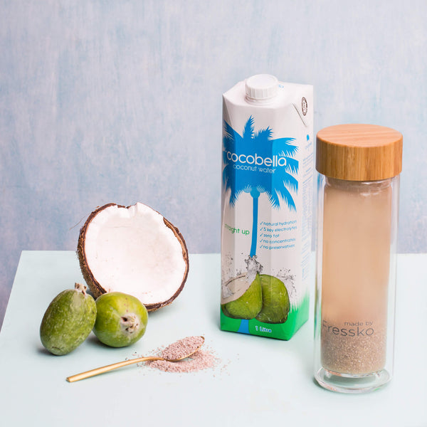 Glass Fressko flask with coconut water coconut and feijoas