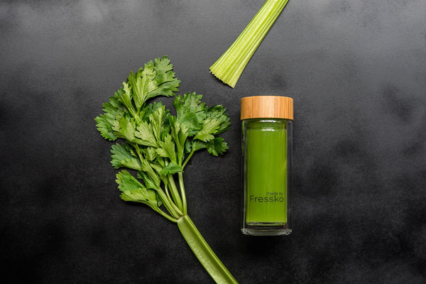 Celery juice in a made by Fressko glass infuser bottle
